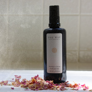 Women’s Circle Multi-Use Mist on a shelf with visible mist—aromatherapy spray for hormonal balance, hot flashes, and mood support.
